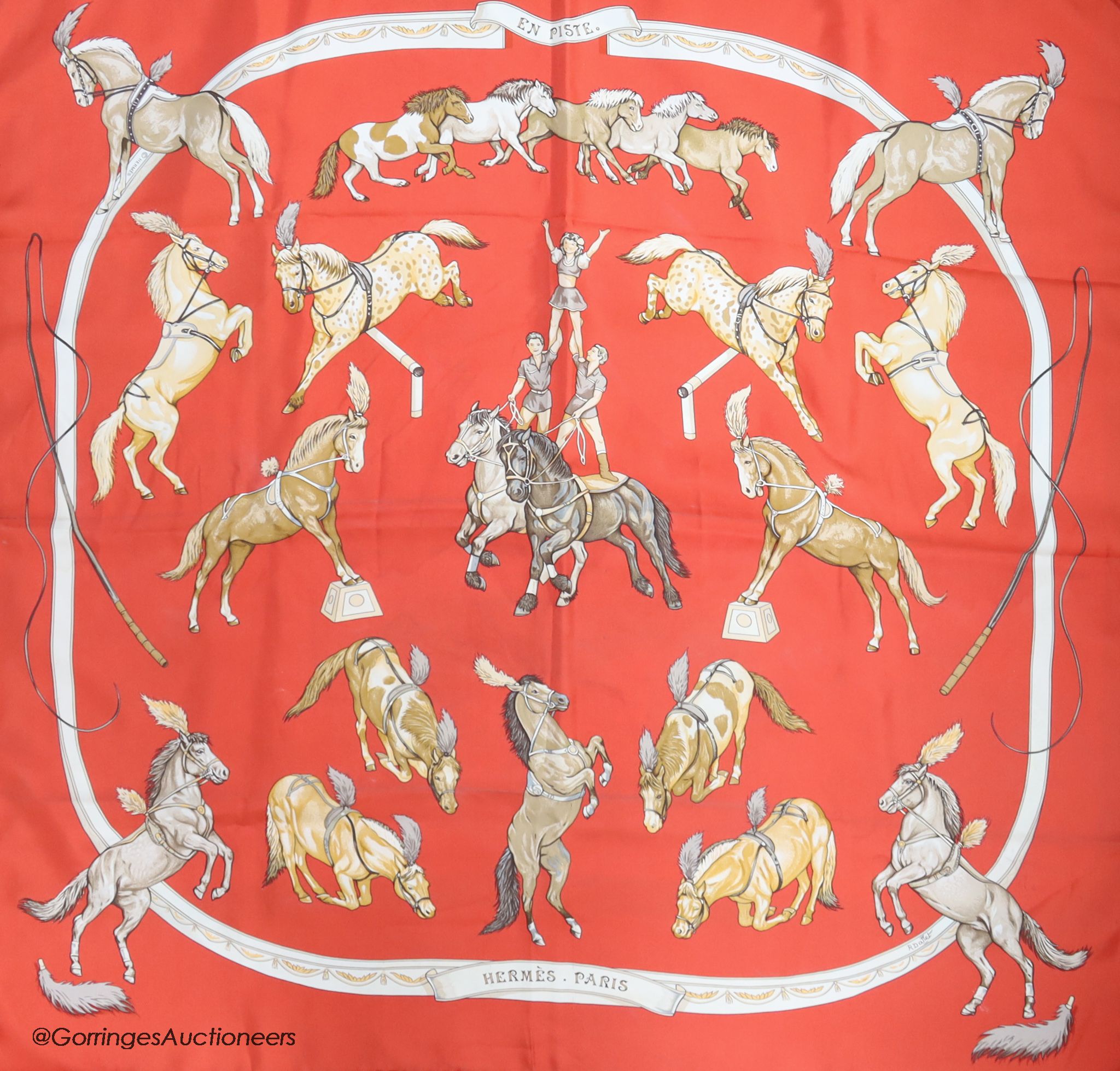 Three vintage Hermes silk scarves, 'Grand Apparat' (red, black and gold), 'En Piste' (red ground) and 'Presentation de Chevaux'